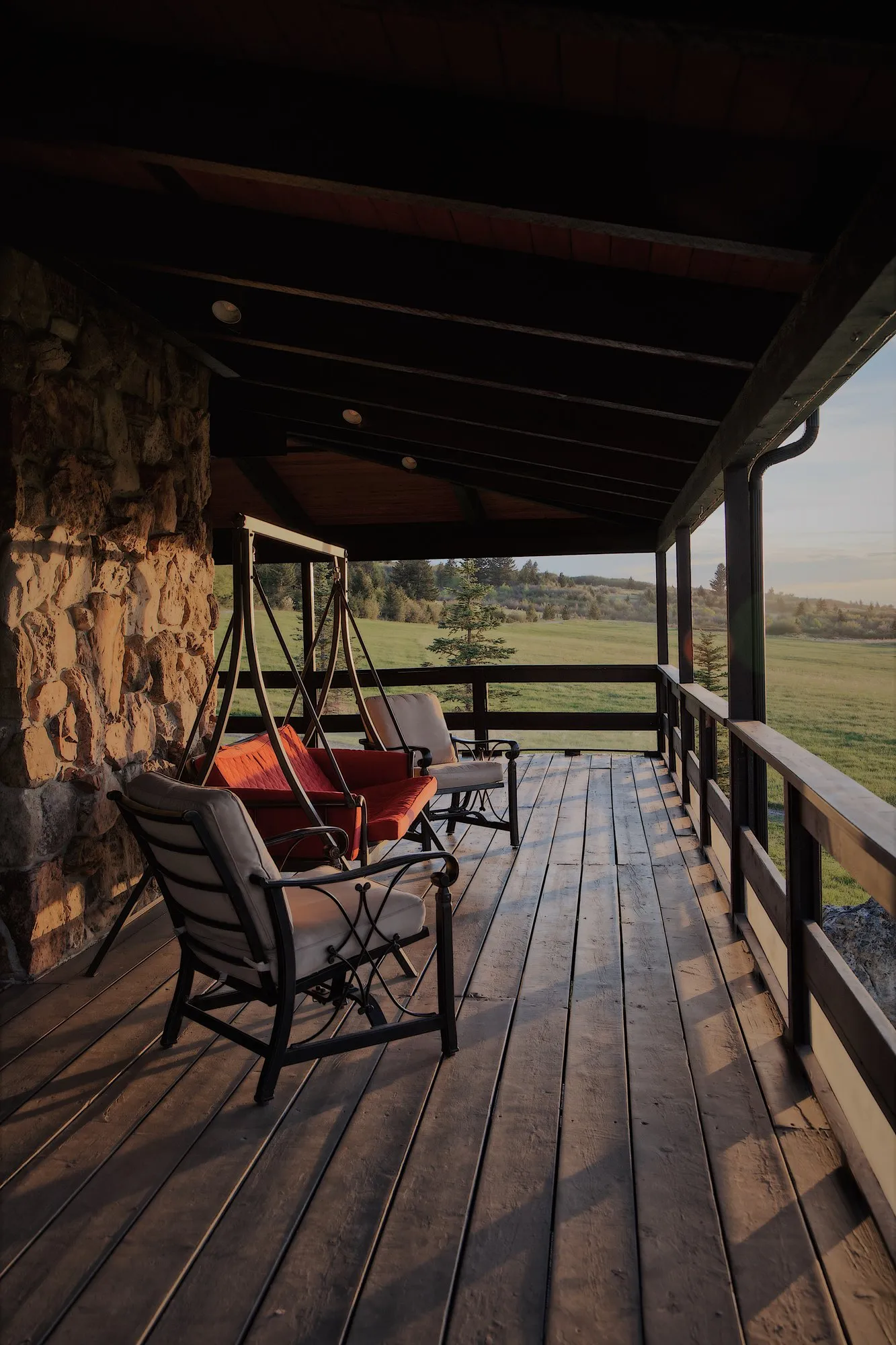 The wraparound porch with swing, late light